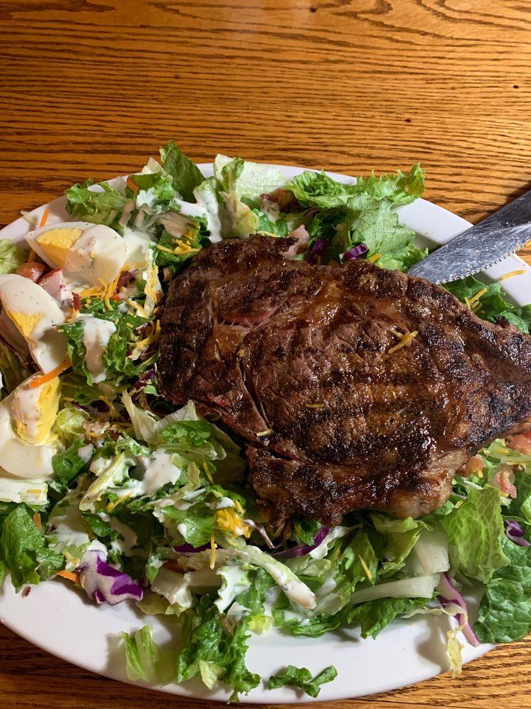 Hand-cut ribeye on a fresh salad at Shumardii's